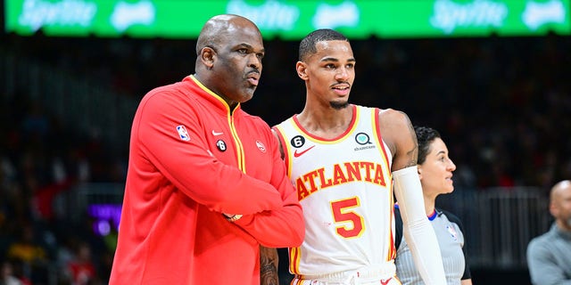 Head Coach Nate McMillan and Dejounte Murray (5) of the Atlanta Hawks during a game Feb. 9, 2023, at State Farm Arena in Atlanta.