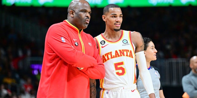 Head Coach Nate McMillan and Dejounte Murray (5) of the Atlanta Hawks during a game Feb. 9, 2023, at State Farm Arena in Atlanta.