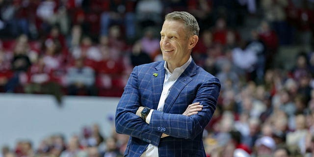 Head coach Nate Oats of the Alabama Crimson Tide smiles after a foul call against his team during the first half against the Georgia Bulldogs at Coleman Coliseum Feb. 18, 2023, in Tuscaloosa, Ala.