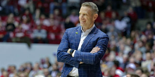 Head coach Nate Oats of the Alabama Crimson Tide smiles after a foul call against his team during the first half against the Georgia Bulldogs at Coleman Coliseum Feb. 18, 2023, in Tuscaloosa, Ala.