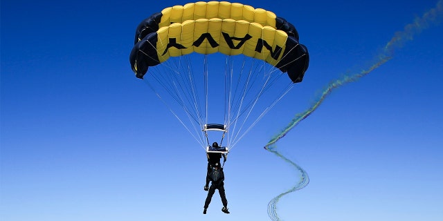 Members of the U.S. Navy Parachute Team, the Leap Frogs, conduct a demonstration jump into Naval Air Station North Island in support of the 245th Navy Birthday on Oct. 13, 2020.