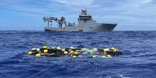 Bags of cocaine, said to have been recovered by NZ Police, Customs and the NZ Defense Force at sea, are seen in a net floating in the Pacific Ocean, in this undated image released on February 8, 2023.