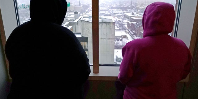 Two women, who were allegedly abused as minors by David Ball, stand in their lawyer's office on Jan. 12, 2023, in Manchester, New Hampshire.