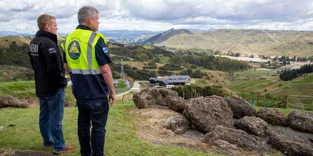 New Zealand's prime minister, left, and Hawke's Bay Civil Defence and Emergency Management Group Controller Ian McDonald access damages from cyclone Gabrielle to the Esk Valley in New Zealand on Feb. 17, 2023. 