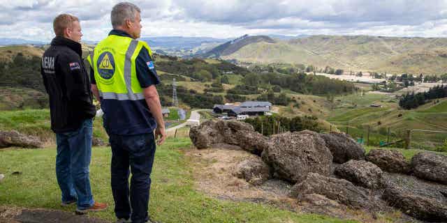 New Zealand's prime minister, left, and Hawke's Bay Civil Defence and Emergency Management Group Controller Ian McDonald access damages from cyclone Gabrielle to the Esk Valley in New Zealand on Feb. 17, 2023.