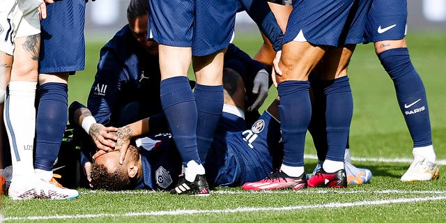 Neymar Junior of Paris Saint-Germain lies injured during the Ligue 1 match between Paris Saint-Germain and Lille OSC at Parc des Princes on February 19, 2023, in Paris.