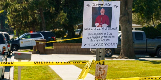 An image of Bishop David O'Connell is posted on the post of a street sign near his home in Hacienda Heights, Calif., Sunday, Feb. 19, 2023. 