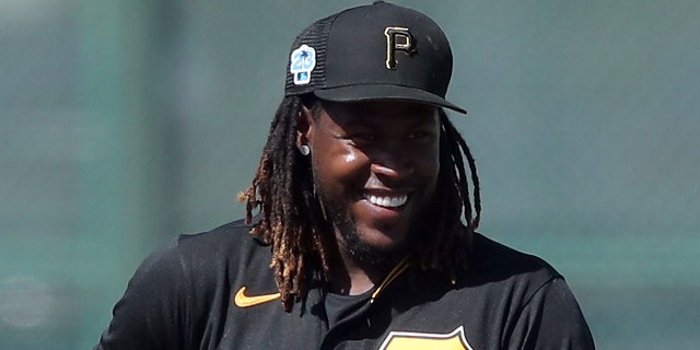 Pittsburgh Pirates shortstop Oneil Cruz (15) smiles after looking down the runner at second base during the spring training game between the Philadelphia Phillies and the Pittsburgh Pirates on February 27, 2023 in LECOM Park in Bradenton, FL.