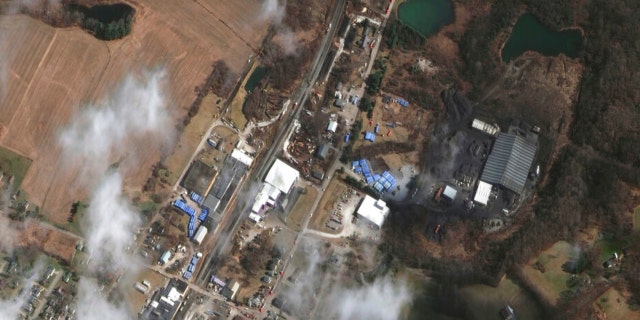 This satellite image provided by Maxar Technologies shows an overview of the aftermath of the Norfolk Southern train derailment on Wednesday, Feb. 15, 2023, in East Palestine, Ohio. About 50 cars derailed in a fiery, mangled mess on the outskirts of East Palestine on Feb. 3. 