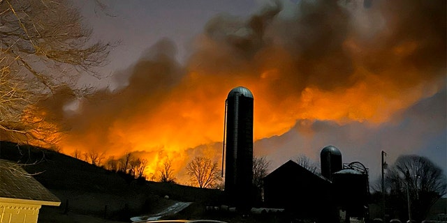 In this photo provided by Melissa Smith, a train fire is seen from her farm in East Palestine, Ohio, Friday, Feb. 3, 2023. 