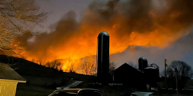 In this photo provided by Melissa Smith, a train fire is seen from her farm in East Palestine, Ohio, Friday, Feb. 3, 2023. 