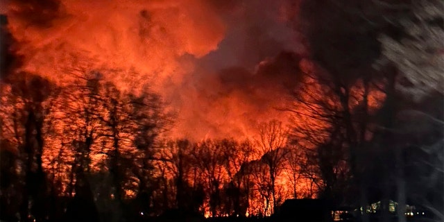 In this photo provided by Melissa Smith, a train fire is seen from her farm in East Palestine, Ohio, Friday, Feb. 3, 2023.