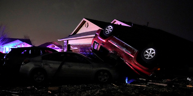 Cars that were hit by a tornado lay in a pile in a damaged neighborhood in Norman, Oklahoma on Tuesday, Feb. 27.