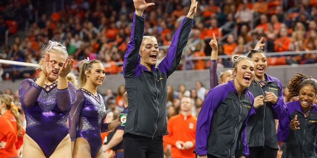 Olivia Dunne of LSU cheers on her teammate during a gymnastics meet against Auburn at Neville Arena on February 10, 2023 in Auburn, Alabama.