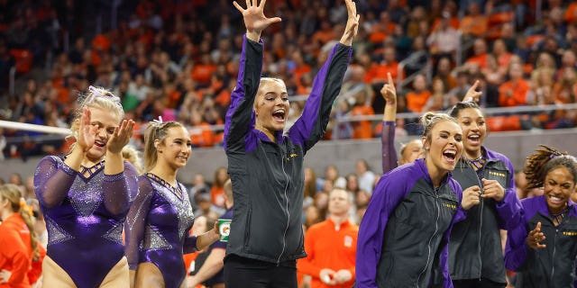 Olivia Dunne of LSU cheers on her teammate during a gymnastics meet against Auburn at Neville Arena on February 10, 2023 in Auburn, Alabama.