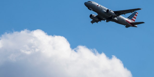 An American Airlines plane takes off from Ronald Reagan Washington National Airport on November 23, 2021, in Arlington, Virginia.