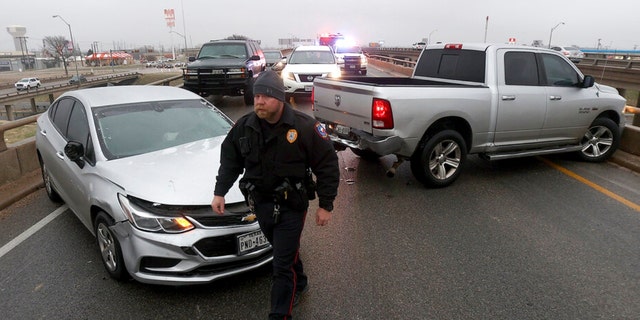 A police officer works the scene of a four-vehicle accident on Highway 6 on Tuesday Jan. 31, 2023, in Waco, Texas.