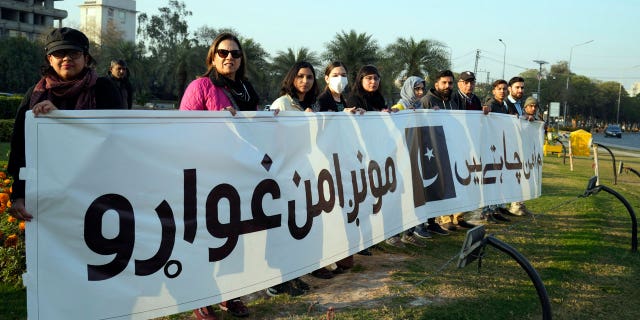 Members of a civil society group take part in a rally during a prayer ceremony for victims of Monday's suicide bombing in Peshawar, in Lahore, Pakistan, on Feb. 4, 2023.
