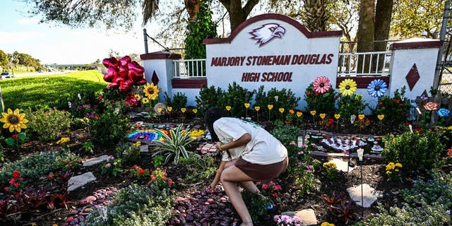 People visit the memorial for the victims of Marjory Stoneman Douglas High School shooting in Parkland, Florida, that killed 17 people, on the fifth anniversary of the massacre on February 14, 2023. - Seventeen people were killed and another seventeen were injured after a 19 year old former student opened fire at the school on February 14, 2018. (Photo by CHANDAN KHANNA / AFP) (Photo by CHANDAN KHANNA/AFP via Getty Images)