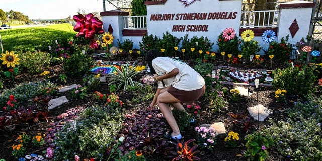 People visit the memorial for the victims of Marjory Stoneman Douglas High School shooting in Parkland, Florida, that killed 17 people, on the fifth anniversary of the massacre on February 14, 2023. - Seventeen people were killed and another seventeen were injured after a 19 year old former student opened fire at the school on February 14, 2018. (Photo by CHANDAN KHANNA / AFP) (Photo by CHANDAN KHANNA/AFP via Getty Images)