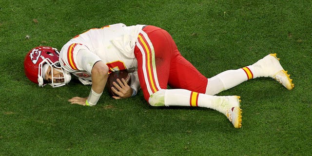 Patrick Mahomes #15 of the Kansas City Chiefs lies on the field with an apparent injury during the second quarter against the Philadelphia Eagles in Super Bowl LVII at State Farm Stadium on February 12, 2023, in Glendale, Arizona.