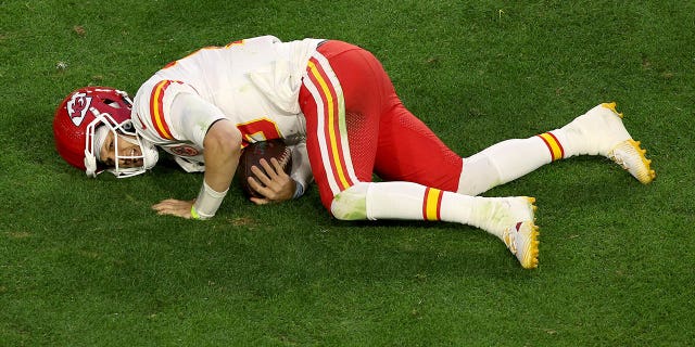 Patrick Mahomes #15 of the Kansas City Chiefs lies on the field with an apparent injury during the second quarter against the Philadelphia Eagles in Super Bowl LVII at State Farm Stadium on February 12, 2023 in Glendale, Arizona.