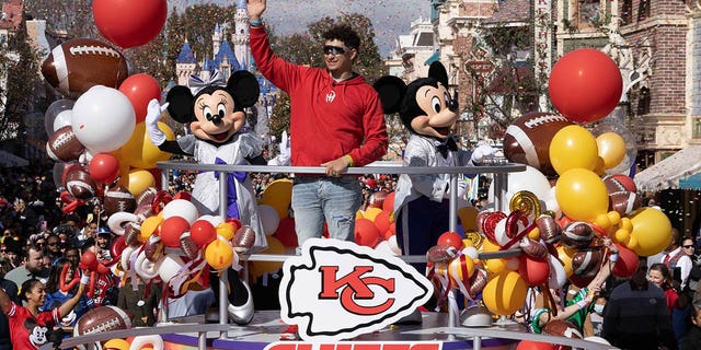 In this image provided by Disney, Patrick Mahomes of the Kansas City Chiefs celebrates his team's Super Bowl victory with a victory parade down Main Street, USA, with Mickey Mouse and Minnie Mouse at Disneyland Park on February 13, 2023 in Anaheim, California.  .
