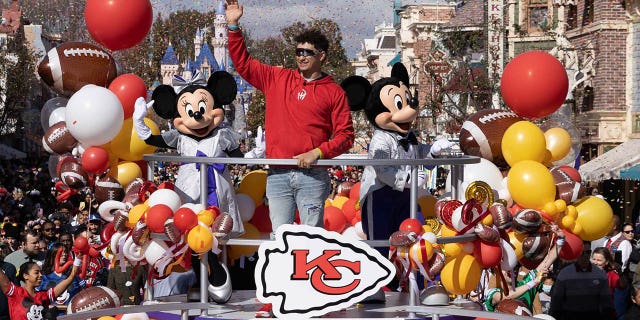 In this image provided by Disney, Patrick Mahomes of the Kansas City Chiefs celebrates his team's Super Bowl victory with a victory parade down Main Street, USA, with Mickey Mouse and Minnie Mouse at Disneyland Park on February 13, 2023 in Anaheim, California.  .