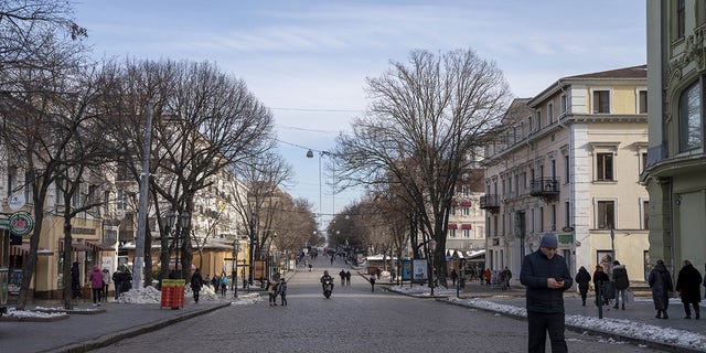 People walk in the streets of Odesa, Ukraine on Feb. 1, 2023. 
