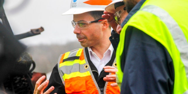 Transportation Secretary Pete Buttigieg tours the site of the Feb. 3, Norfolk Southern train derailment, Thursday, Feb. 23, 2023, in East Palestine, Ohio.