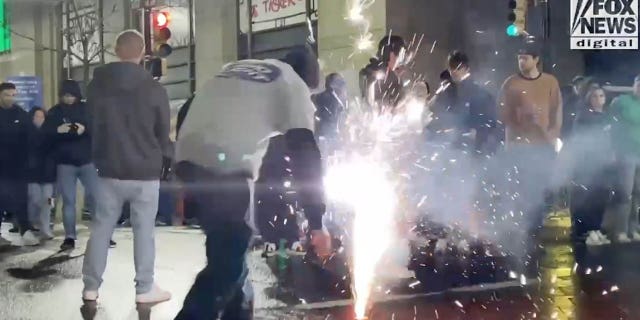 Eagles fan shows up to set off fireworks on the road.