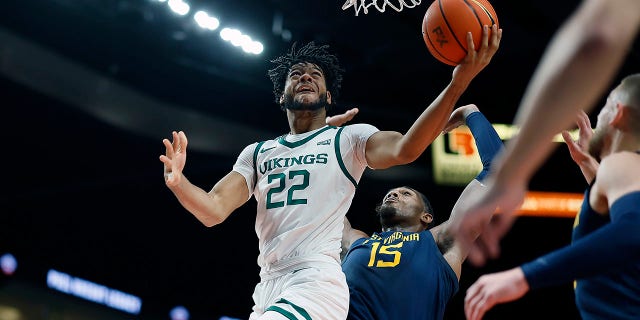 Isaiah Johnson (22) of the Portland State Vikings shoots under pressure from Jimmy Bell Jr. (15) of the West Virginia Mountaineers during the first half at Moda Center Nov. 25, 2022, in Portland, Ore.