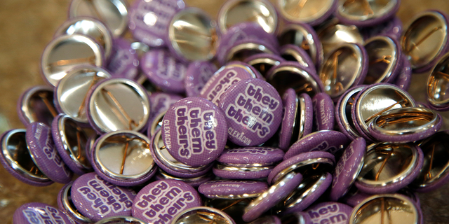 Buttons with the "they, them, theirs" pronouns are displayed during the ClexaCon 2021 convention at the Tropicana Las Vegas on October 09, 2021, in Las Vegas, Nevada. (Photo by Gabe Ginsberg/Getty Images)