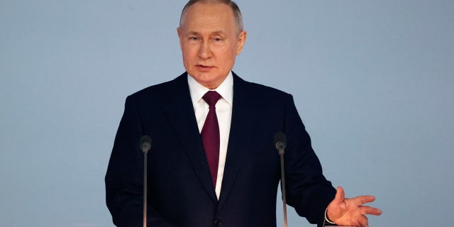 Russian President Vladimir Putin gestures as he gives his annual state of the nation address in Moscow, Russia, Tuesday, Feb. 21, 2023.