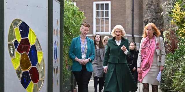 Camilla, Queen Consort, center, talks with Coram CEO Carol Homden, right, and Head of Coram Beabstalk, Amy Lewis, during a visit on Feb. 2, 2023 in London.