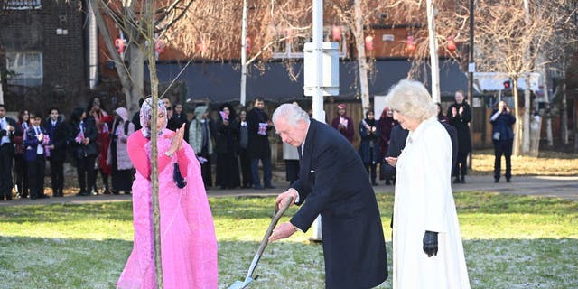 King Charles III, center, and Camilla, Queen Consort, right, plant a tree in the Altab Ali Park during a visit to the Bangladeshi community of Brick Lane on Feb. 8, 2023 in London.