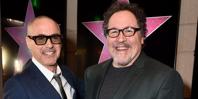 Robert Downey Jr., left, and Jon Favreau attend Favreau's Walk of Fame ceremony.