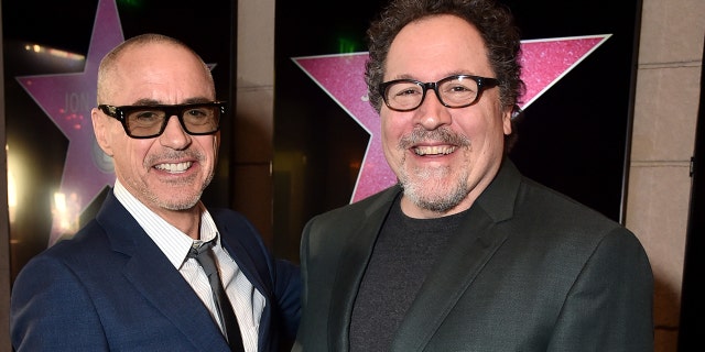Robert Downey Jr., left, and Jon Favreau attend Favreau's Walk of Fame ceremony.