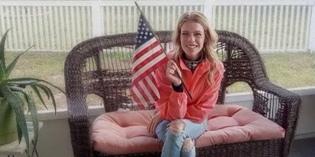 Rachel Schwartz waves an American flag in the porch in an undated family photo.