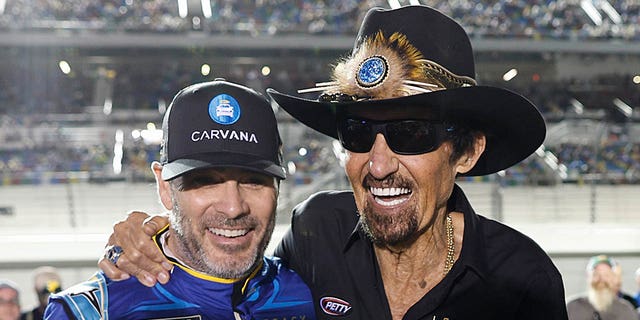 Jimmie Johnson and Richard Petty pose for photos at Daytona International Speedway on Feb. 16, 2023, in Daytona Beach, Florida.