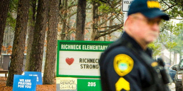 A Newport News police officer directs traffic at Richneck Elementary School in Newport News, Va., on Monday Jan. 30, 2023.  The Virginia elementary school where a six-year-old boy shot his teacher reopened on that date with stepped-up security and a new administrator. 