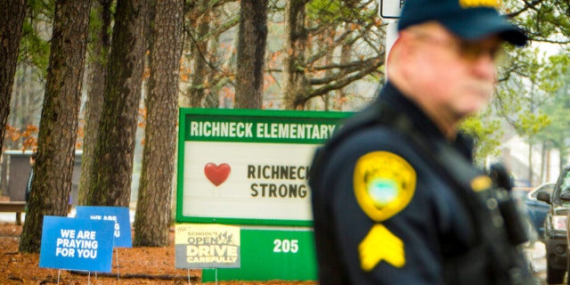 A Newport News police officer directs traffic at Richneck Elementary School in Newport News, Va., on Monday Jan. 30, 2023.  The Virginia elementary school where a six-year-old boy shot his teacher reopened on that date with stepped-up security and a new administrator. 