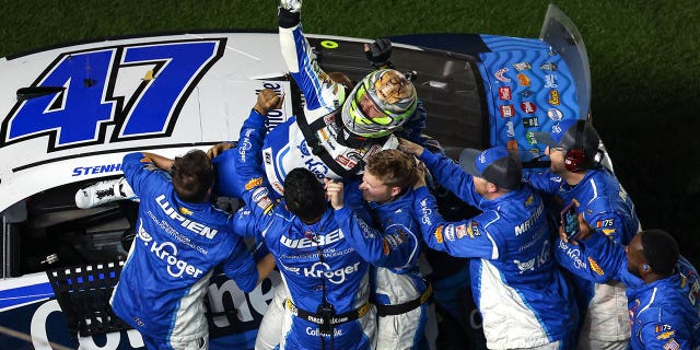 Ricky Stenhouse Jr., driver of the #47 Kroger/Cottonelle Chevrolet, celebrates with his crew after winning the 65th annual NASCAR Cup Series Daytona 500 at Daytona International Speedway on February 19, 2023.