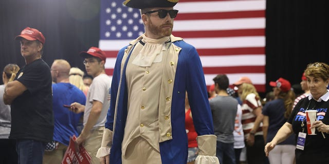 Rogan O'Handley dressed as a patriot, awaits the arrival of President Donald Trump at a Make America Great Again Rally at the Florida State Fair Grounds Expo Hall on July 31, 2018, in Tampa, Florida. O'Handley is best known as dc_draino on Instagram, where has 2.3 million followers. 