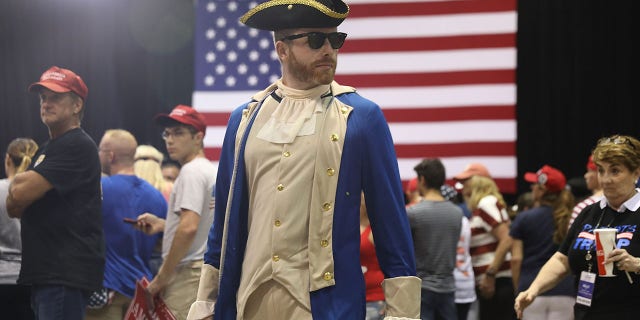 Rogan O'Handley dressed as a patriot, awaits the arrival of President Donald Trump at a Make America Great Again Rally at the Florida State Fair Grounds Expo Hall on July 31, 2018, in Tampa, Florida. O'Handley is best known as dc_draino on Instagram, where has 2.3 million followers. 