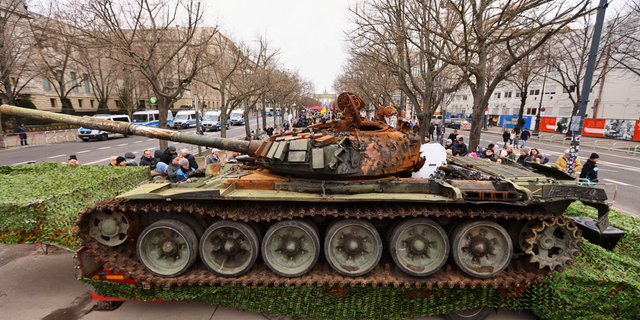 The remains of a destroyed Russian T-72 tank, secured from the Ukrainian village of Dmytrivka, outside Kyiv are on display near the the Brandenburg Gate during an event to mark the one-year anniversary of the Russian invasion of Ukraine, in Berlin, Germany, on Feb. 24.