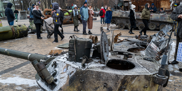 People look at destroyed Russian military vehicles on display in Kyiv on Jan. 29, 2023.