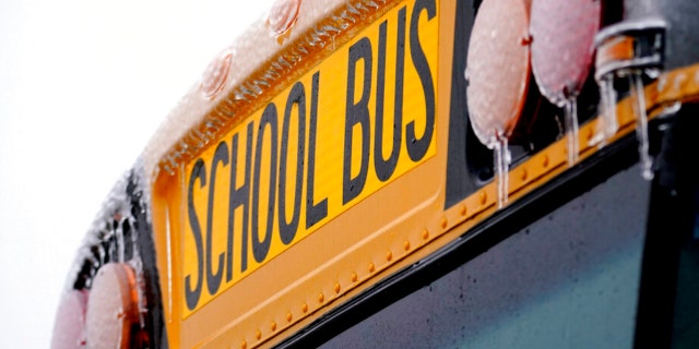 Icicles from sleet and rain coat a Richardson Independant School Bus that sits parked, Thursday, Feb. 2, 2023, in Richardson, Texas. Several school districts in the region have been closed the past three days because of the winter storm.