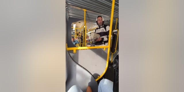 A man was caught on video throwing eggs at a San Francisco bus passenger after allegedly yelling racial slurs at two Asian women. 