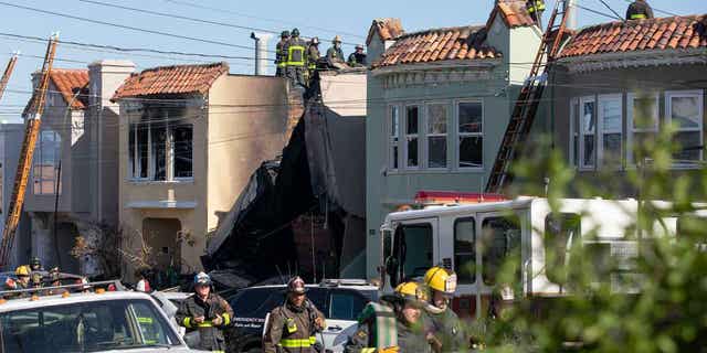 Firefighters battle a house fire after an explosion in the Sunset District on Feb. 9, 2023, in San Francisco, California. The explosion injured a firefighter and a civilian.